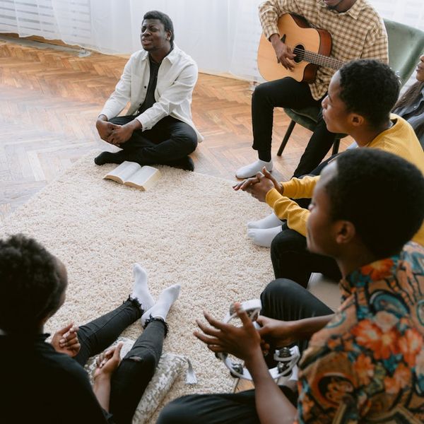 A diverse group of people sitting comfortably in a circle.