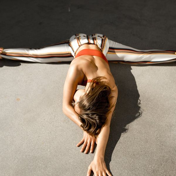Person in a stretching pose, demonstrating physical flexibility and focus.